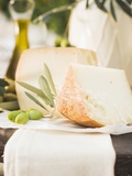 Cheese  Green Olives and Olive Oil on Table Out of Doors