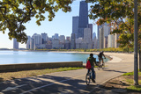 Cyclists Riding Along Lake Michigan Shore with the Chicago Skyline Beyond  Chicago  Illinois  USA
