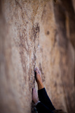 A Rock Climber's Hands Grip the Granite High Above the Ground