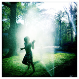 Kids Playing in a Front Yard Sprinkler