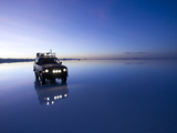 A 4X4 Rests in the Early Am Reflection in a Flooded Salt Flat In