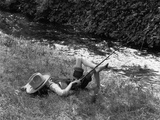 Boy Fishing with Hat Over Face