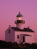 Lighthouse Against a Pink Sky at Twilight